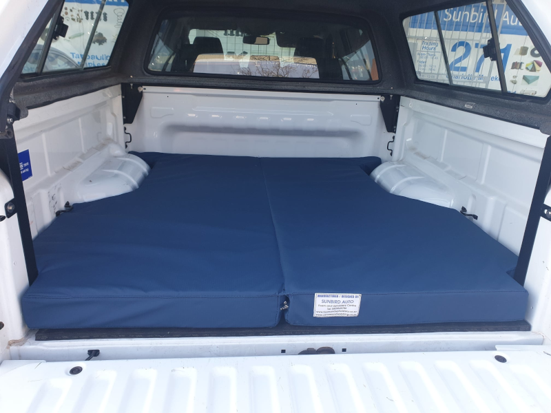 Blue two-piece custom bakkie mattress in a bakkie canopy