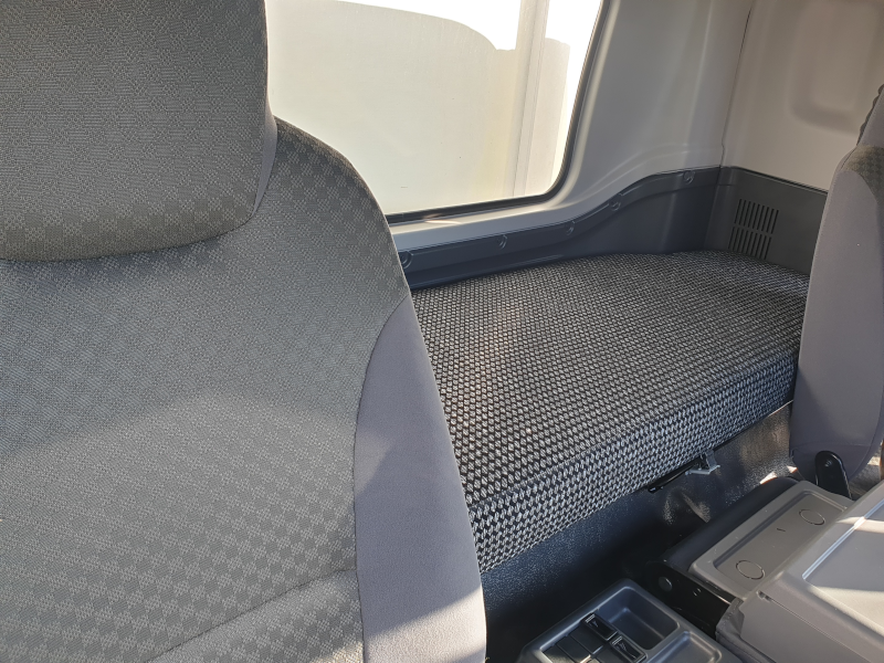 Grey truck cabin mattress fitted behind the driver seat